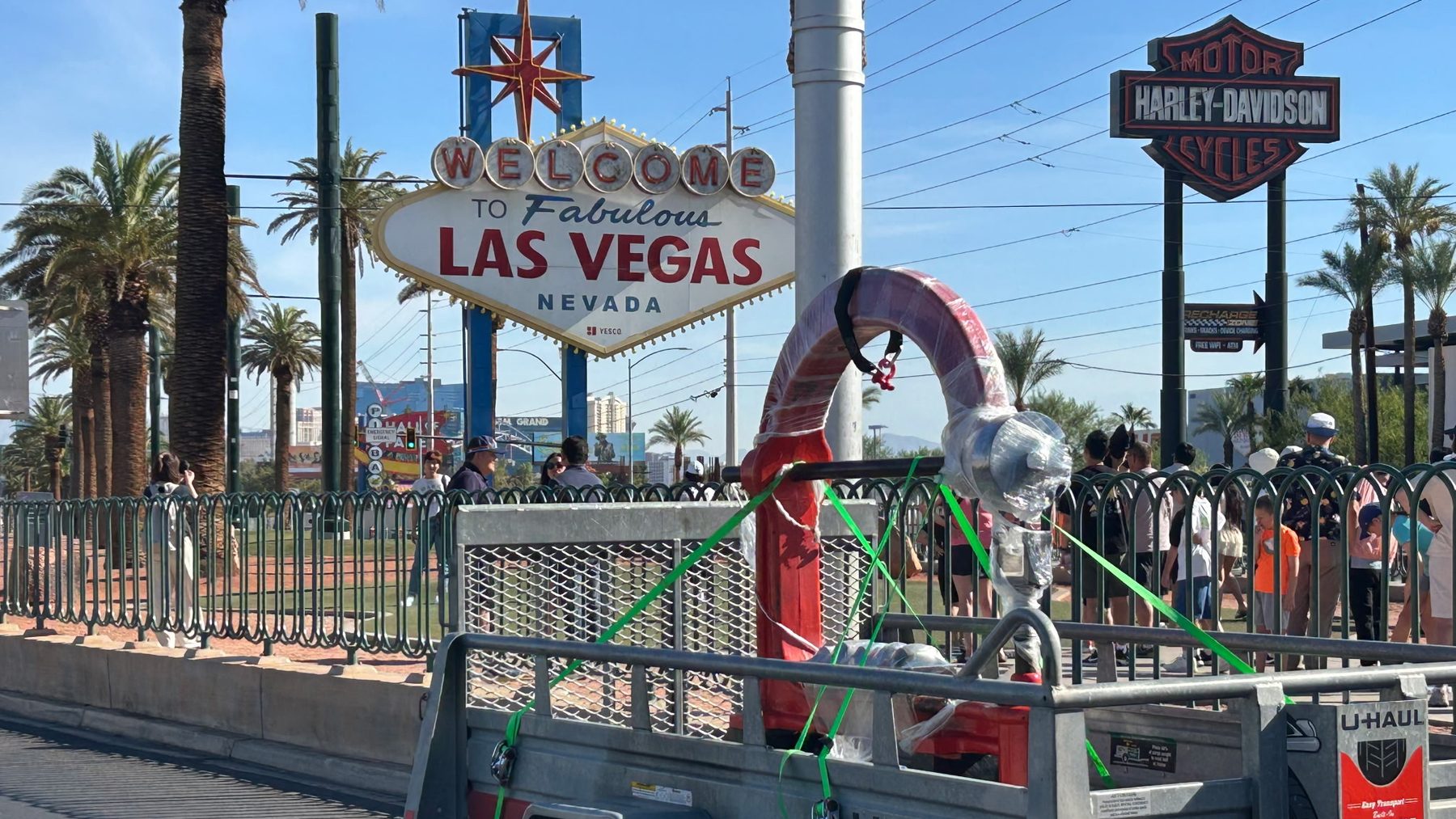 An English wheel strapped to a trailer in front of the Welcome to Fabulous Las Vegas sign, delivered by Quinn Bros Industries